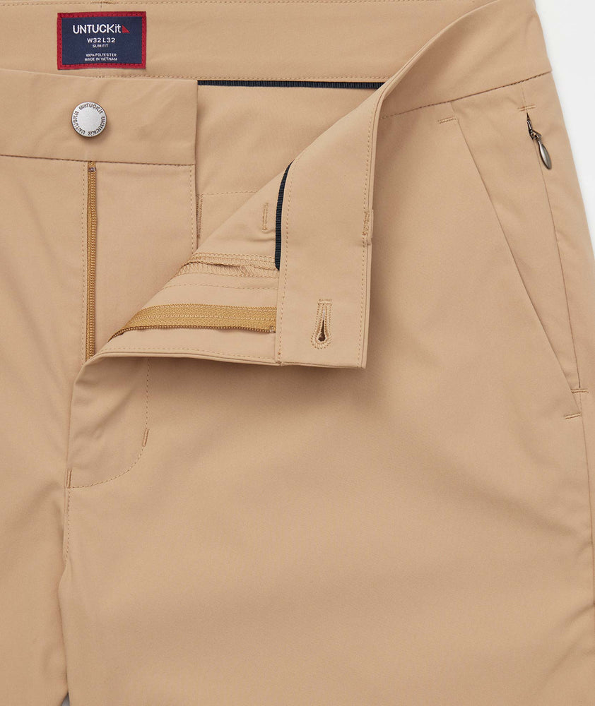 Model is wearing UNTUCKit Chancellor pants in khaki.