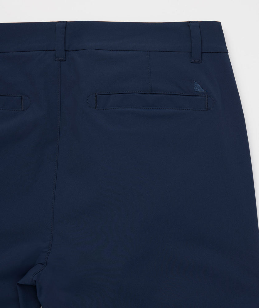 Model is wearing UNTUCKit Chancellor pants in navy.