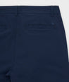 Model is wearing UNTUCKit Chancellor pants in navy.