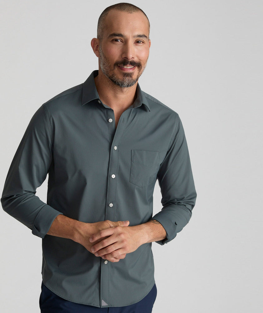 Model is wearing UNTUCKit girone performance shirt in urban chic.