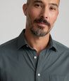 Model is wearing UNTUCKit girone performance shirt in urban chic.
