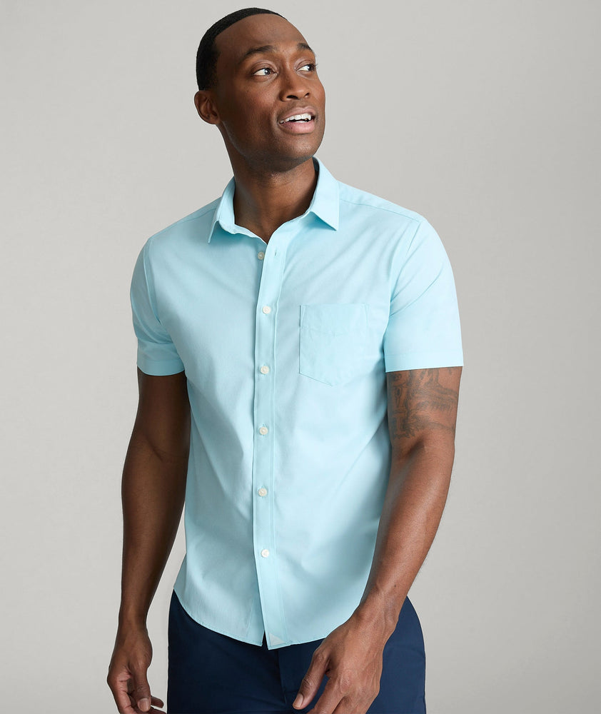 Model is wearing UNTUCKit gironde shirt in corydalis blue.