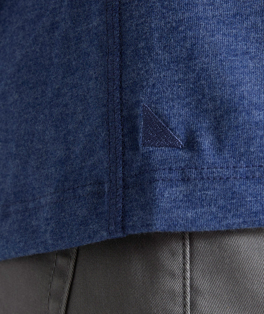 Model is wearing UNTUCKit Jericho henley in solid blue.