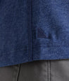 Model is wearing UNTUCKit Jericho henley in solid blue.