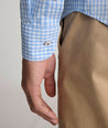Model is wearing UNTUCKit Lawrence wrinkle free in light blue gingham.
