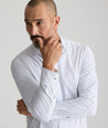 Model is wearing UNTUCKit Mckenzie bluebell shirt in white grounded dot print.
