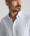 Model is wearing UNTUCKit Mckenzie bluebell shirt in white grounded dot print.