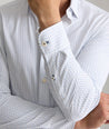 Model is wearing UNTUCKit Mckenzie bluebell shirt in white grounded dot print.