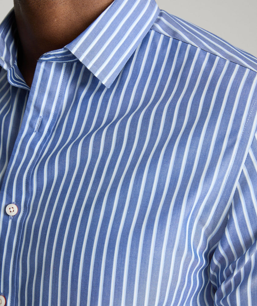 Model is wearing UNTUCKit Roy wrinkle-free shirt in blue.