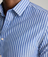 Model is wearing UNTUCKit Roy wrinkle-free shirt in blue.