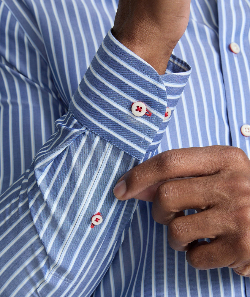 Model is wearing UNTUCKit Roy wrinkle-free shirt in blue.