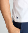 Model is wearing UNTUCKit saxum tee in white.