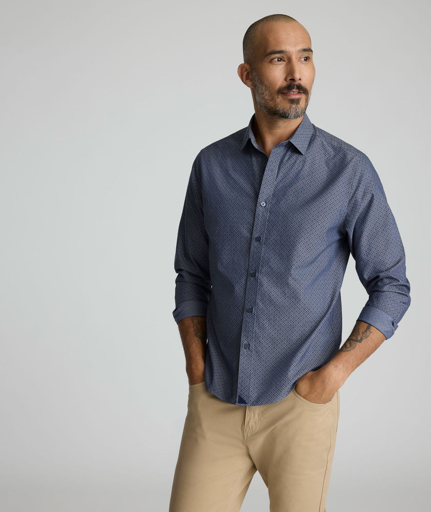 Model is wearing UNTUCKit Smithson wrinkle-free shirt in gray.