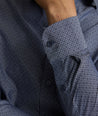 Model is wearing UNTUCKit Smithson wrinkle-free shirt in gray.