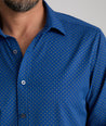 Model is wearing UNTUCKit Stanton shirt in blue Dimond print.