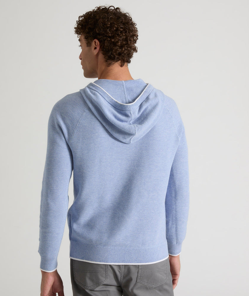 Model is wearing UNTUCKit Walcott cotton hoodie in heather blue.