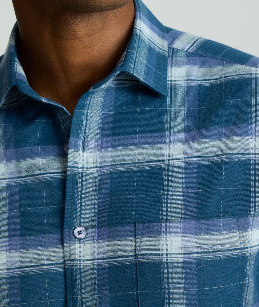 Model is wearing UNTUCKit Barker performance flannel in blue plaid. 