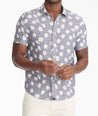 Model is wearing UNTUCKit bonner short sleeve shirt in Chambray Floral. 