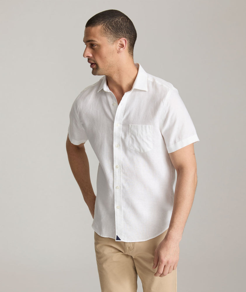 Model wearing an UNTUCKit Bright White Wrinkle-Resistant Linen Short-Sleeve Cameron Shirt.