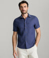 Model wearing an UNTUCKit Navy Wrinkle-Resistant Linen Short Sleeve Cameron Shirt.