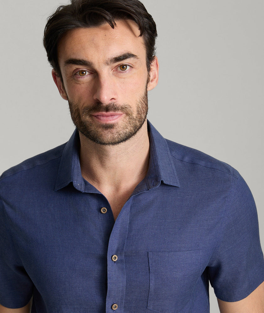 Model wearing an UNTUCKit Navy Wrinkle-Resistant Linen Short Sleeve Cameron Shirt