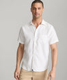 Model wearing an UNTUCKit Bright White Wrinkle-Resistant Linen Short-Sleeve Cameron Shirt.