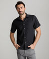 Model wearing an UNTUCKit Black Wrinkle-Resistant Linen Short Sleeve Cameron Shirt.