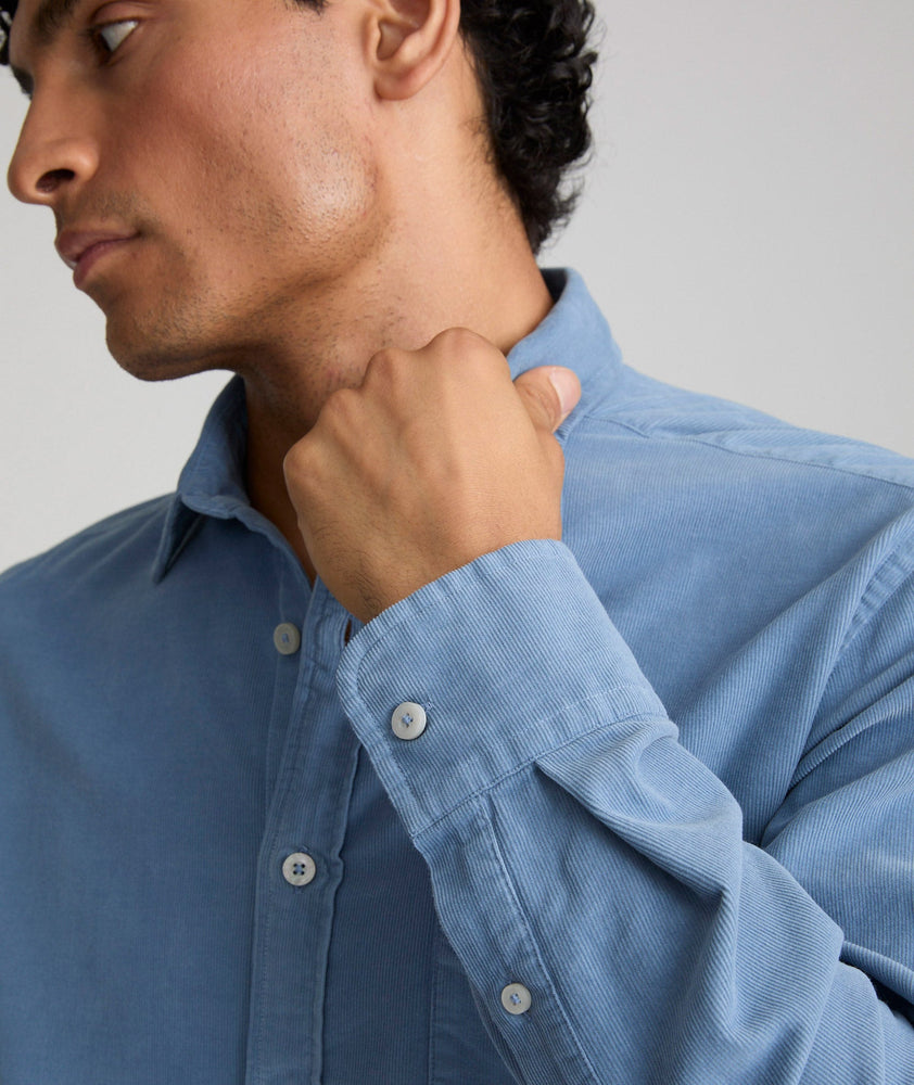 Model is wearing UNTUCKit Caprone Cord Shirt in Faded Blue.