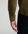 Model is wearing UNTUCKit Caprone Cord Shirt in dark olive.