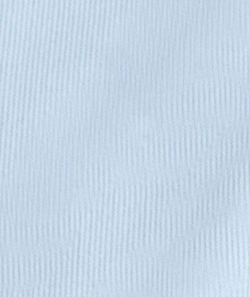 Model is wearing UNTUCKit Cord Shirt in heather blue. 