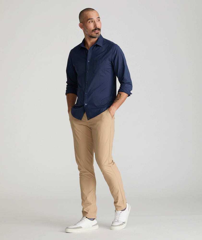 Model is wearing UNTUCKit Chancellor pants in khaki. 