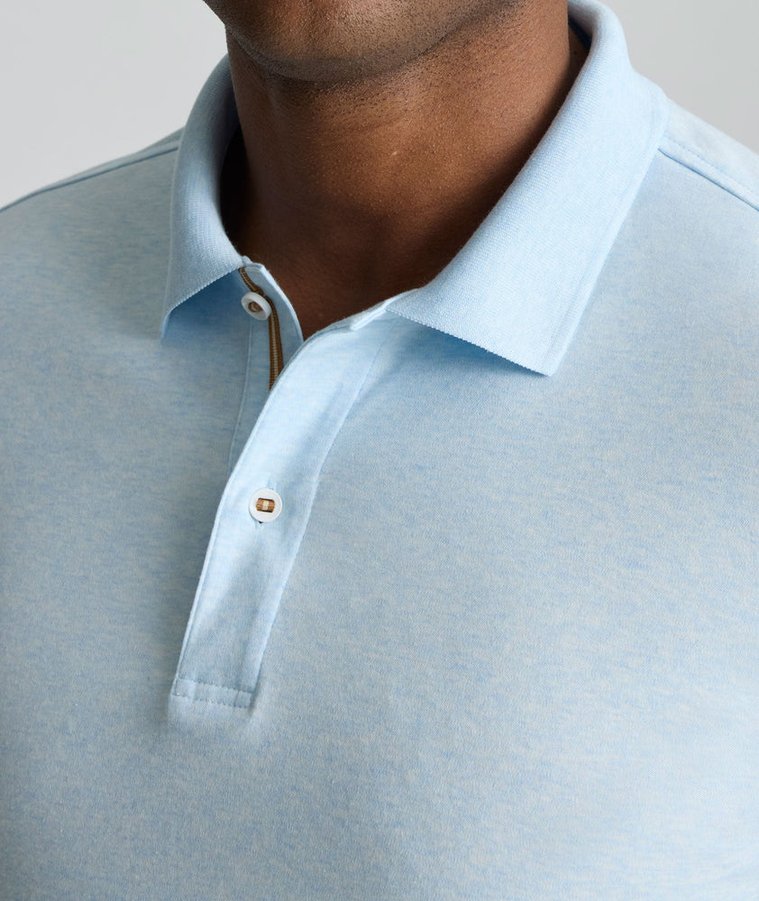 Model is wearing UNTUCKit Wrinkle-Free Damaschino Polo in heather blue. 