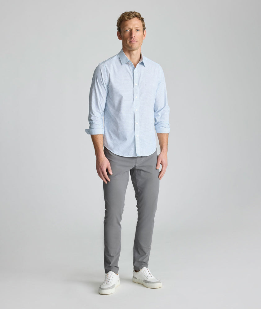 Model is wearing UNTUCKit Performance Fairfax Shirt in blue. 