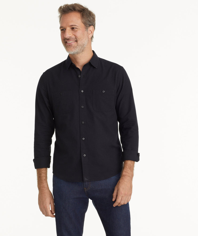 Model is wearing Flannel Hemsworth Shirt in Black Herringbone.