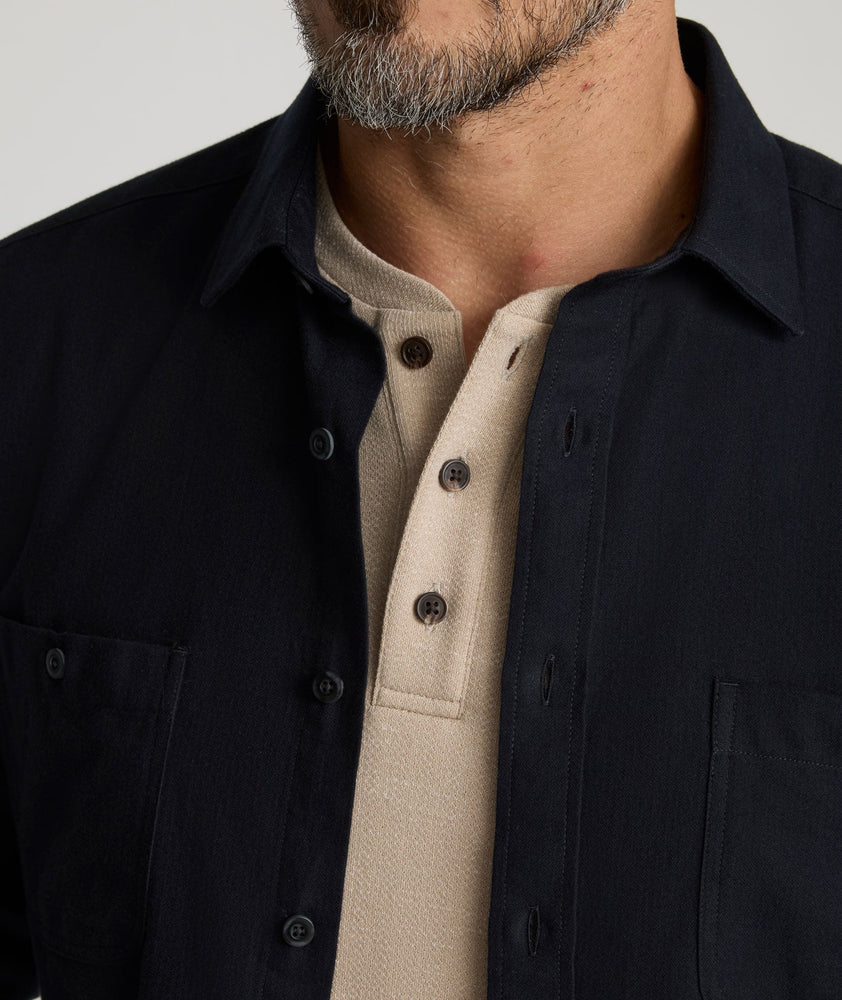 Model is wearing Flannel Hemsworth Shirt in Black Herringbone.