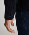 Model is wearing Flannel Hemsworth Shirt in Black Herringbone.