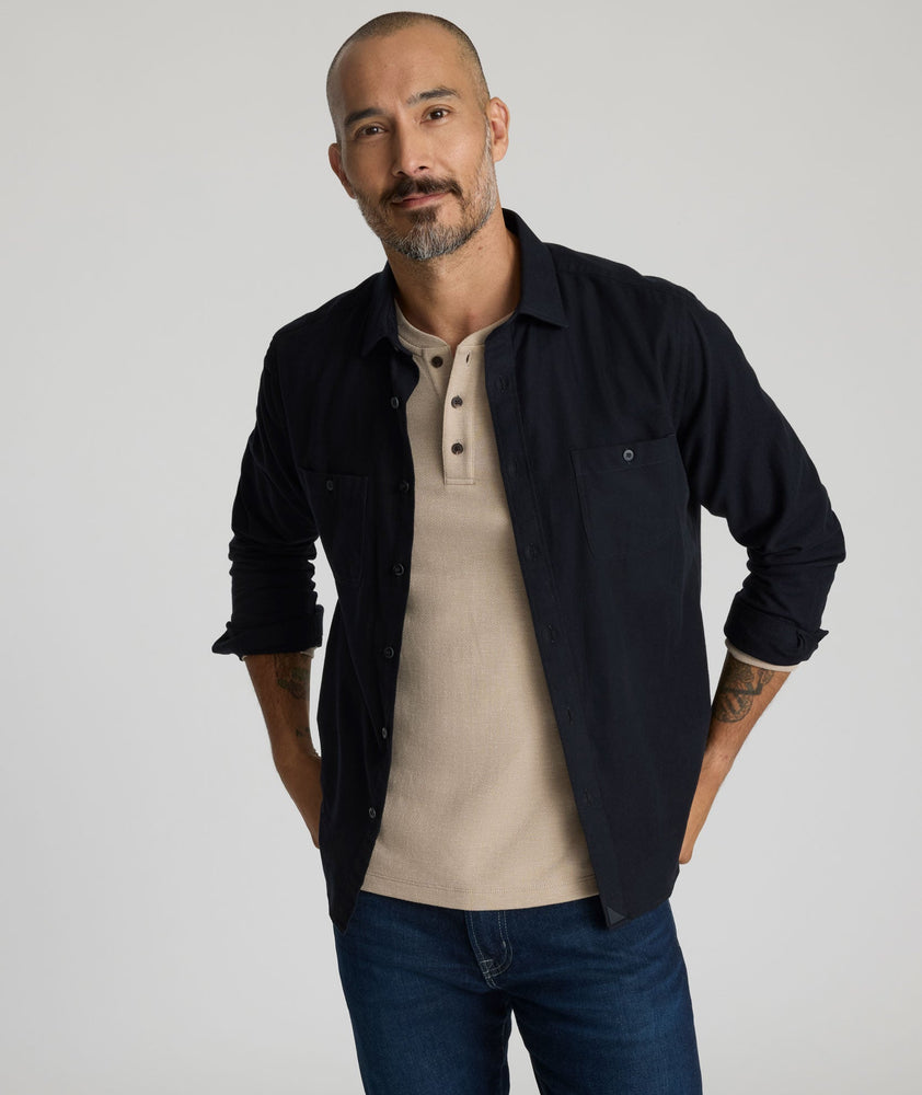 Model is wearing Flannel Hemsworth Shirt in Black Herringbone.
