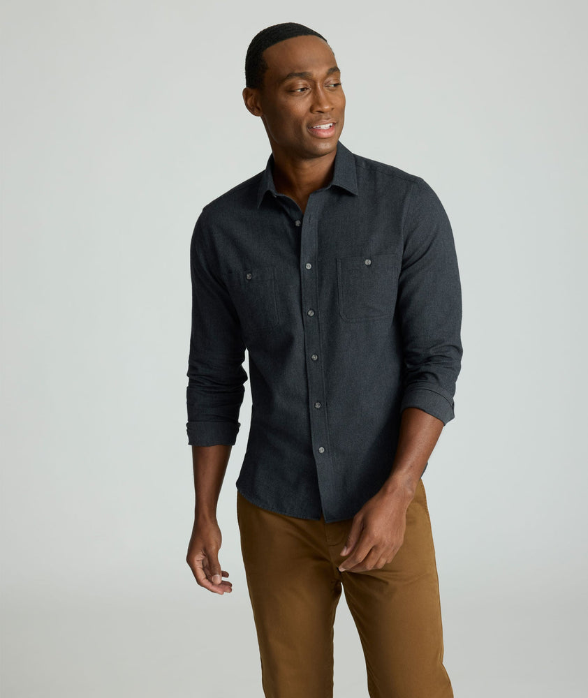 Model is wearing UNTUCKit Flannel Hemsworth Shirt in Deep Gray Herringbone.