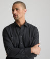 Model is wearing UNTUCKit Flannel Hemsworth Shirt in Deep Gray Herringbone.