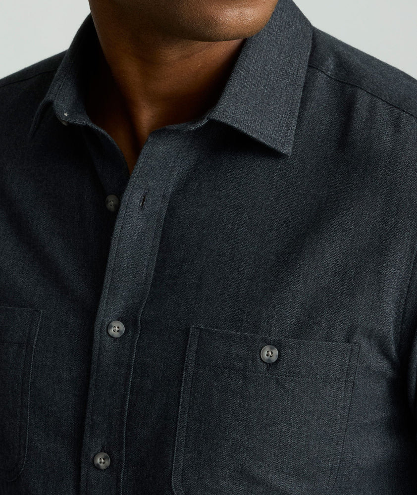 Model is wearing UNTUCKit Flannel Hemsworth Shirt in Deep Gray Herringbone.