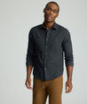 Model is wearing UNTUCKit Flannel Hemsworth Shirt in Deep Gray Herringbone.