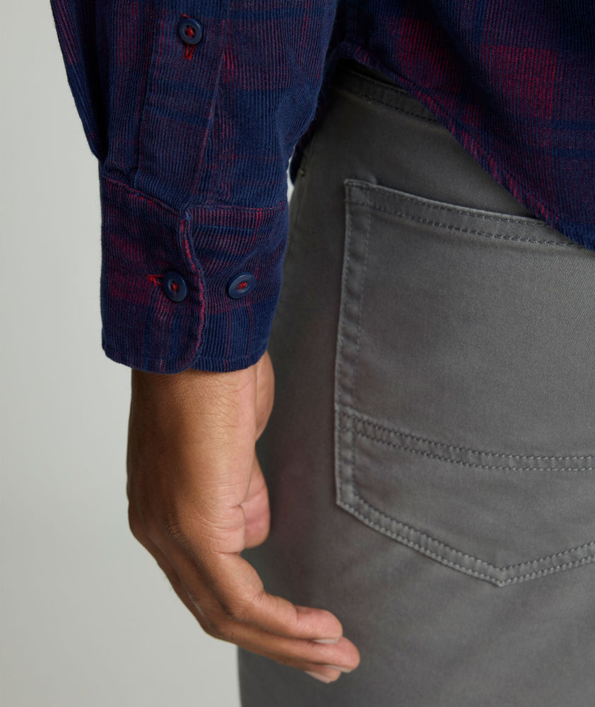 Model is wearing UNTUCKit Cord Shirt in blue and purple plaid. 