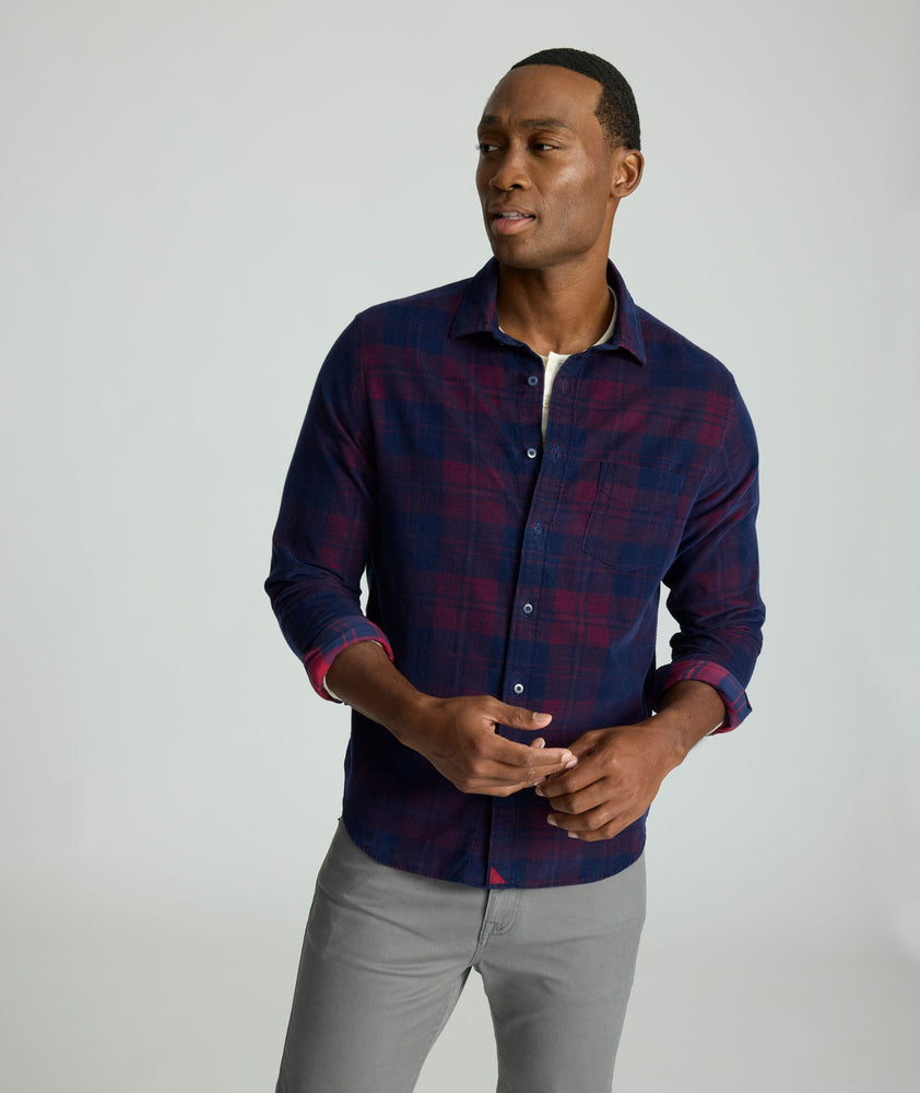 Model is wearing UNTUCKit Cord Shirt in blue and purple plaid. 