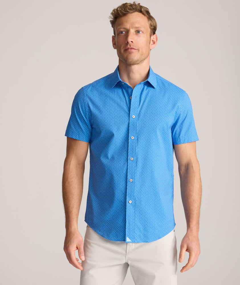 Model is wearing UNTUCKit Performance Short-Sleeve Livingston Shirt in Blue Shark Fin Print.