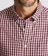 Model is wearing UNTUCKit Wrinkle-Free Marchand Shirt in Black, Red, & White Plaid.