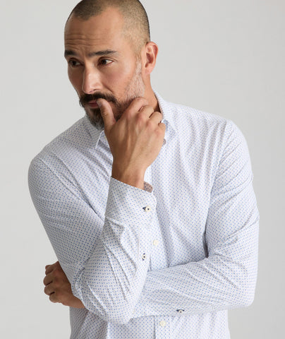 Model is wearing UNTUCKit Mckenzie bluebell shirt in white grounded dot print. 