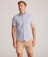 Model is wearing UNTUCKit Performance Short-Sleeve Nouveau Shirt in Navy Geo Print.