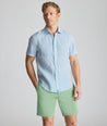 Model is wearing UNTUCKit Linen Short-Sleeve Redcroft Shirt. 