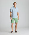 Model is wearing UNTUCKit Linen Short-Sleeve Redcroft Shirt. 