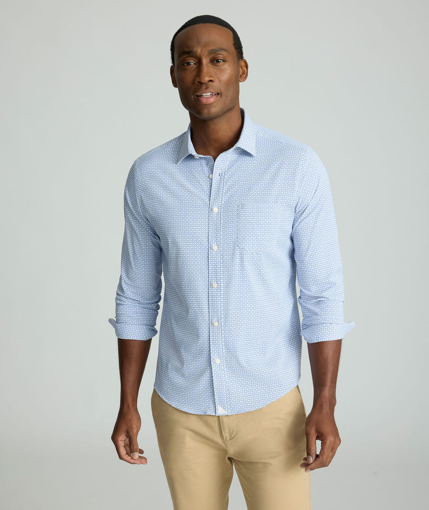 Model is wearing UNTUCKit Performance Shirt with Pocket in Blue Circle Print.